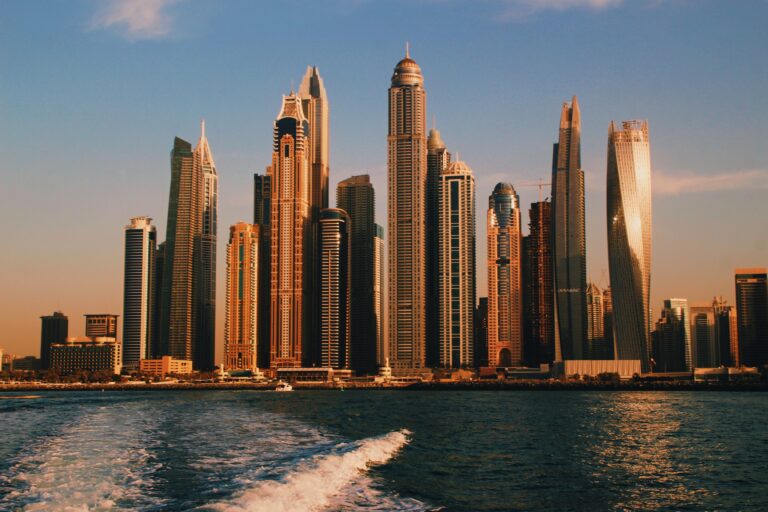 Dubai's remarkable skyscrapers shown from a boat during sunset / places like Dubai