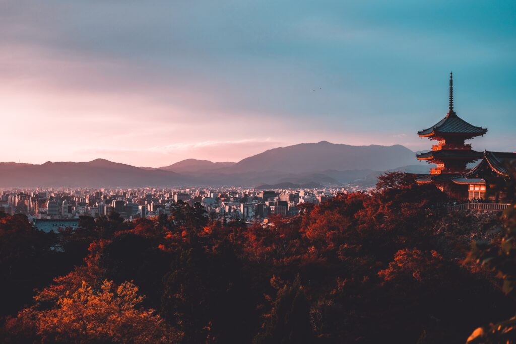 stunning skyline at sunset in Kyoto, Japan showcasing a dense city among the mountains and temples 