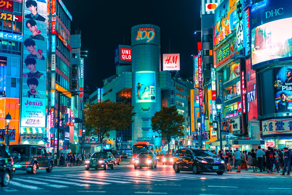 several bright lights displayed on buildings in one of Tokyo's most famous city intersections