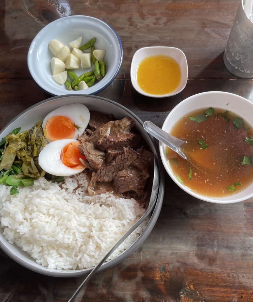slow cooked beef paired with rice, egg and soup stock on the side at Ancient Beef in Chiang Mai 