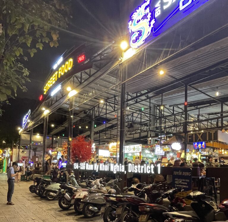 plenty of motorbikes parked outside the popular Ben Nghe Street Food Market in Ho Chi Minh City during the evening