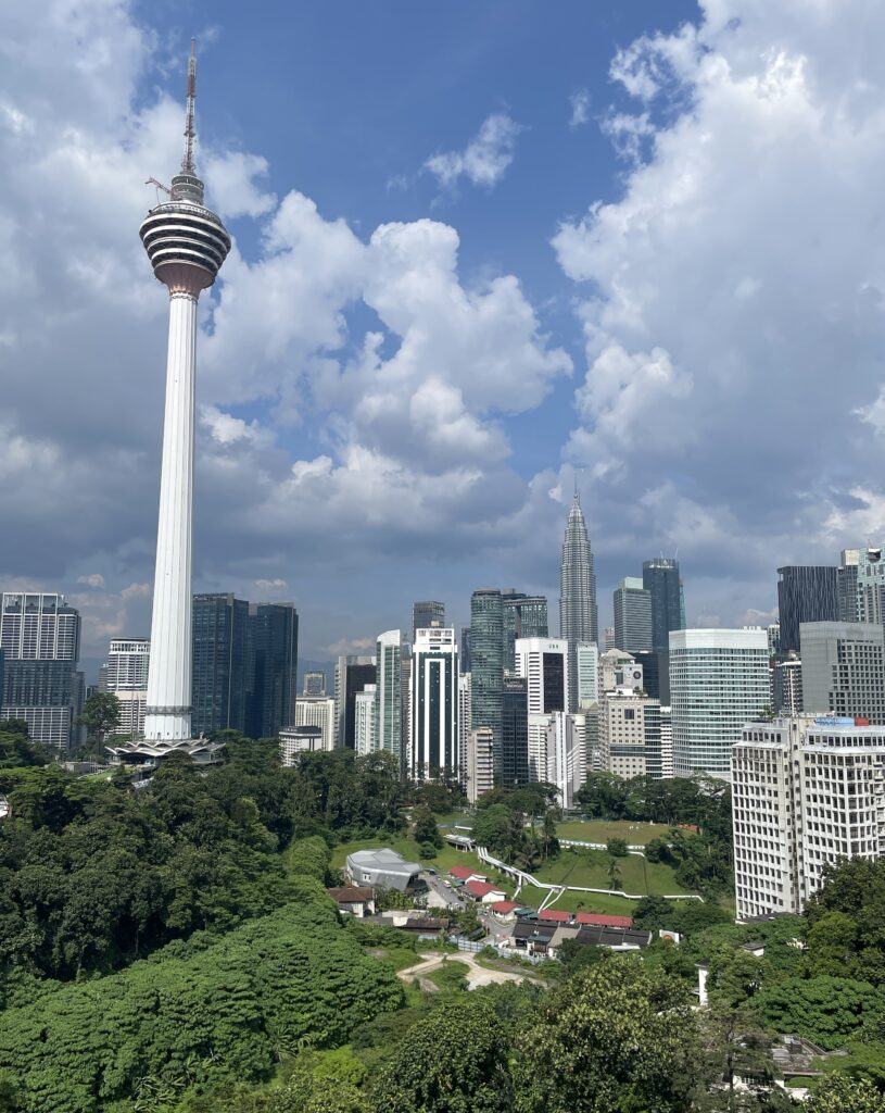 the stunning Kuala Lumpur skyline from a rooftop on a bright sunny day 