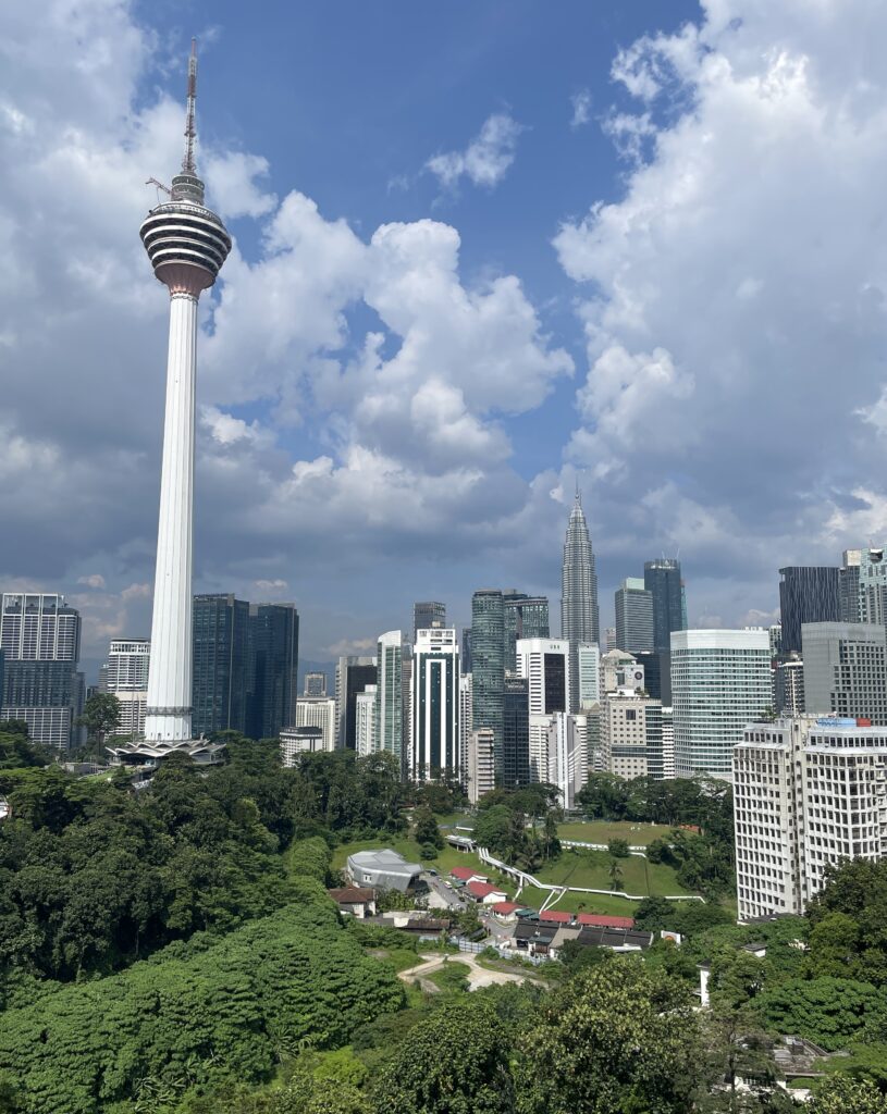 the stunning Kuala Lumpur skyline from a rooftop on a bright sunny day