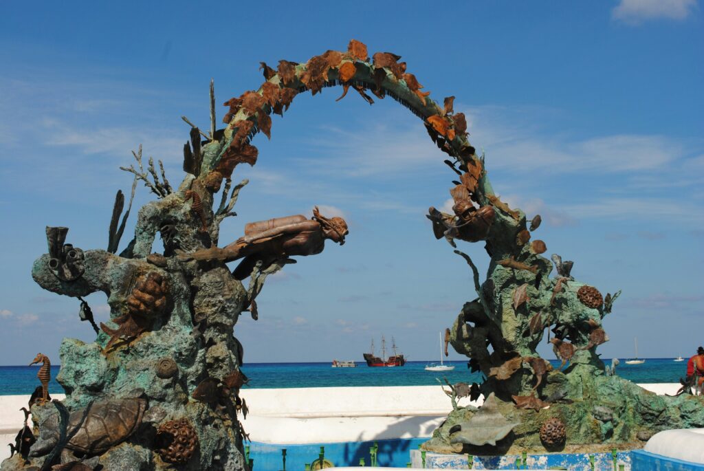 a beautiful sculpture at a white sandy beach in Cozumel, Mexico / how to get around Cozumel