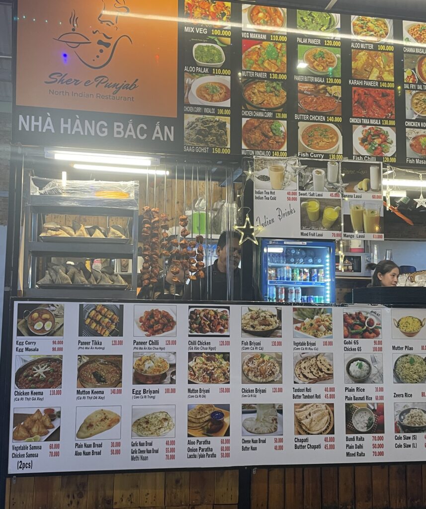 Indian street food stall at the Ben Nghe Night Market showing their large extensive menu of many Indian dishes 