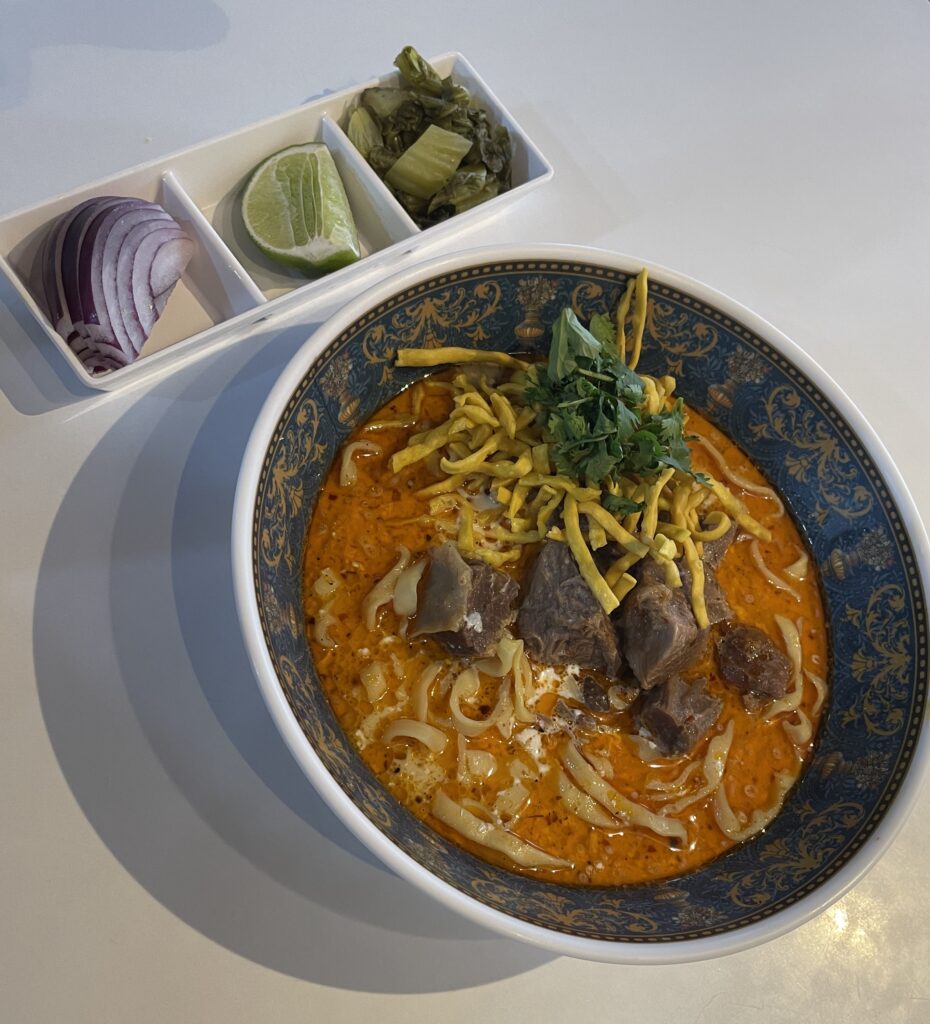 KHao Soi served with onion and lime at Khao Soi Doi Nang in Chiang Mai 