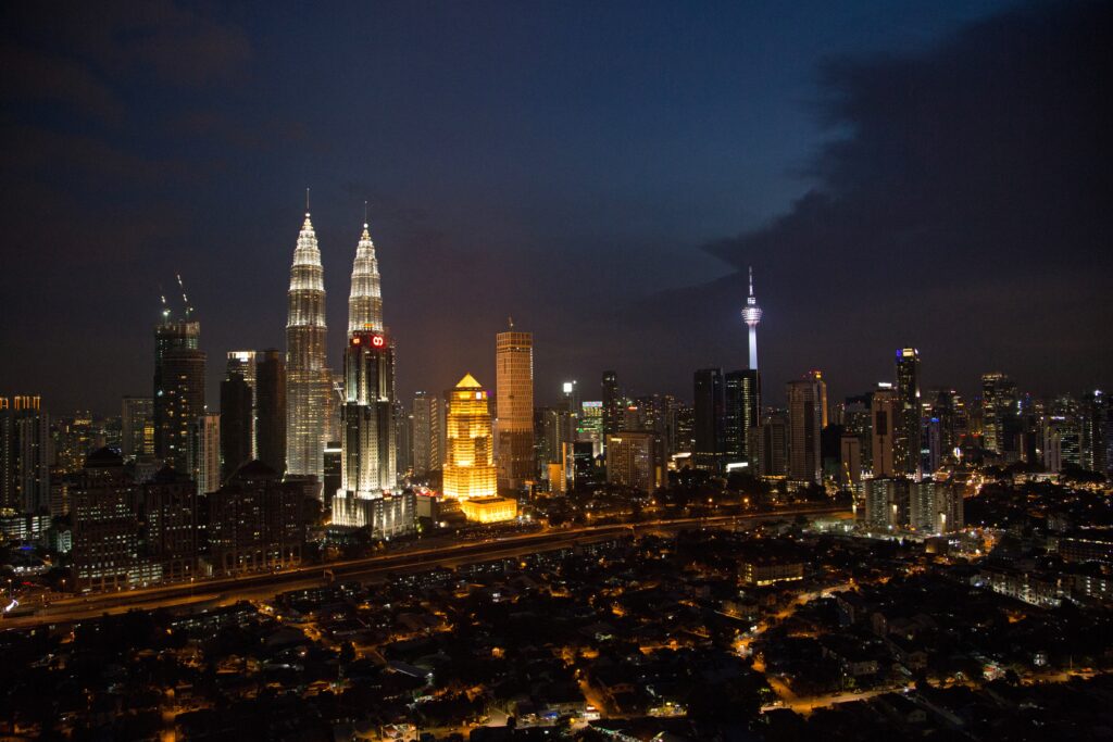 amazing panoramic views of the Kuala Lumpur skyline from a rooftop at night 
