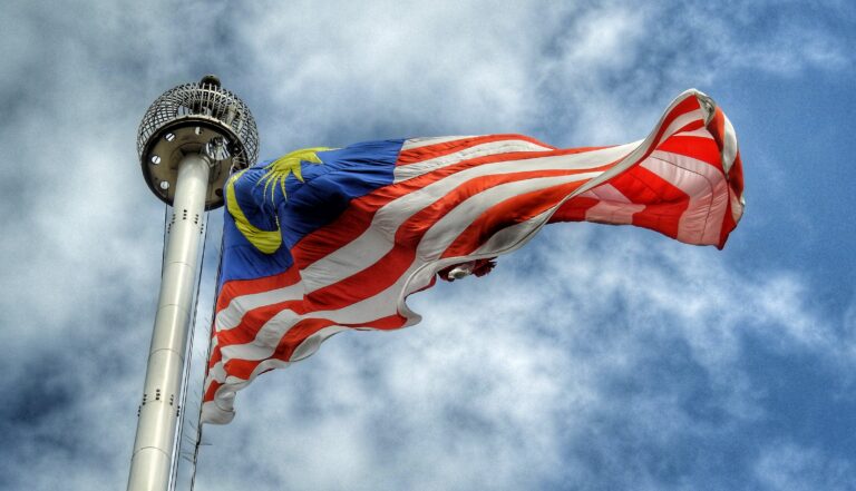 Malaysian flag flying high against clear blue skies in Malaysia