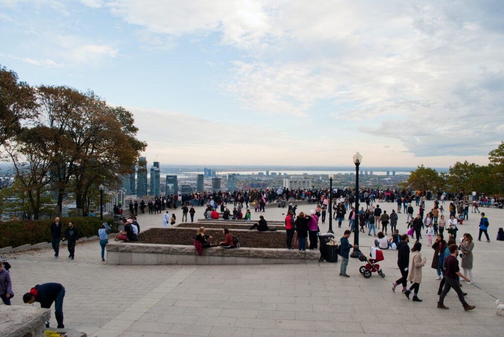 many tourists walking around a famous viewpoint at Mount Royal Park in Montreal 