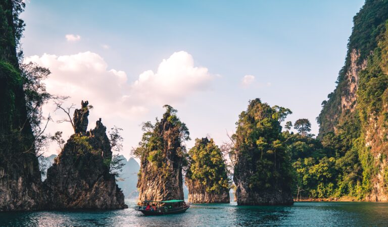 several large limestones in the lakes of Khao Sok National Park in Thailand / how to get from Phuket Airport to Khao Sok National Park