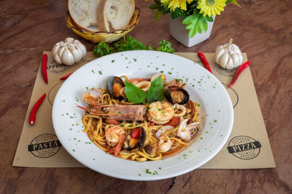 a flavourful seafood pasta being served at Pomodoro Italian restaurant in Kata Beach
