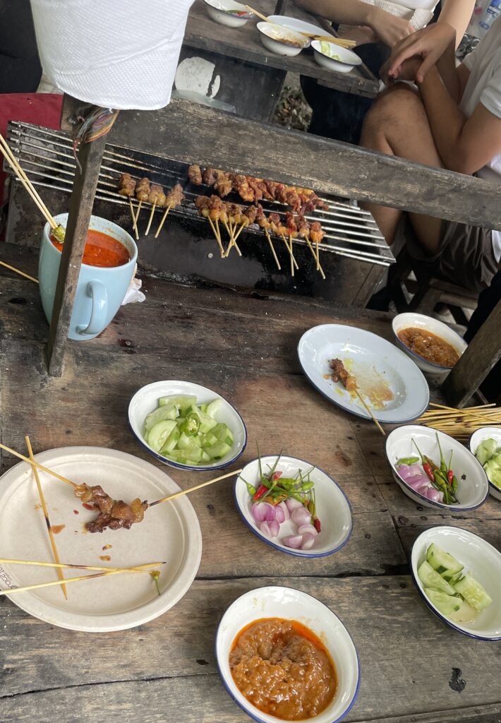 several locals and tourist surrounded by the Satay Queen in Chiang Mai 