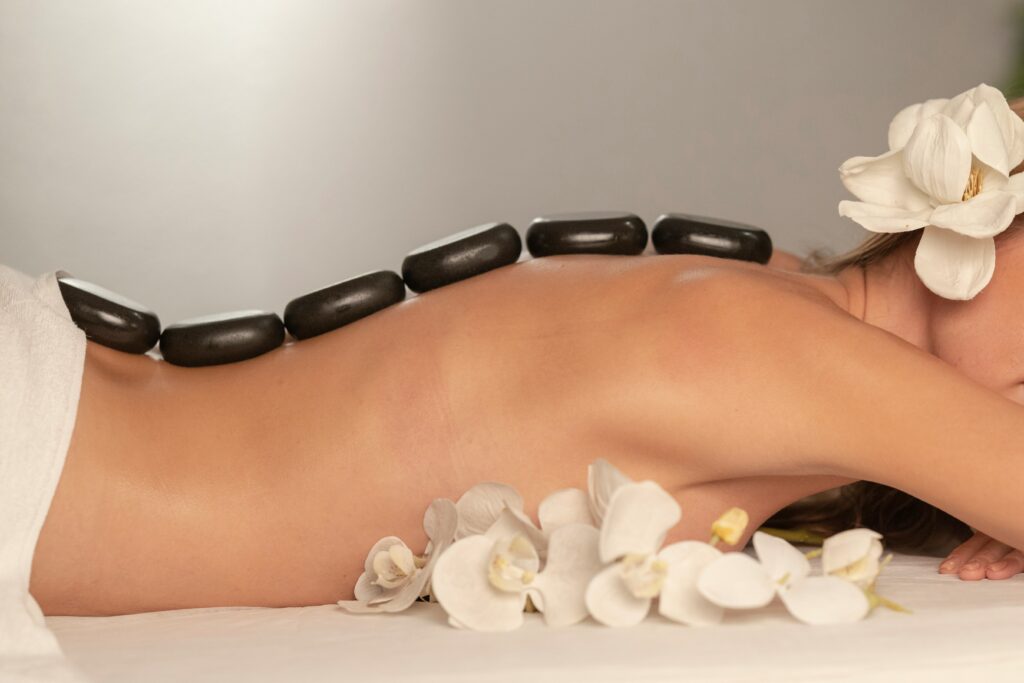 many stones on a womans back as she reserves a hot stone massage 