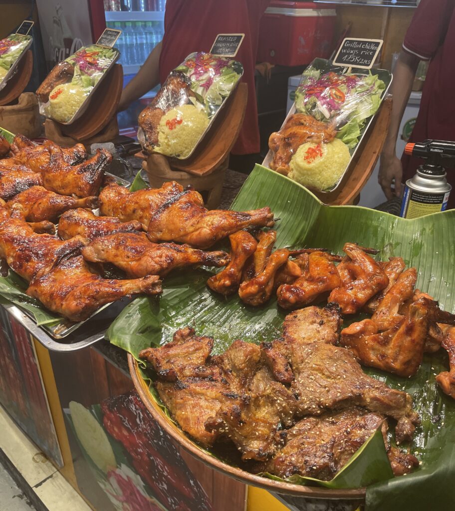 large pieces of glazed chicken up for display to purchase at a street food market in Ho Chi Minh City 