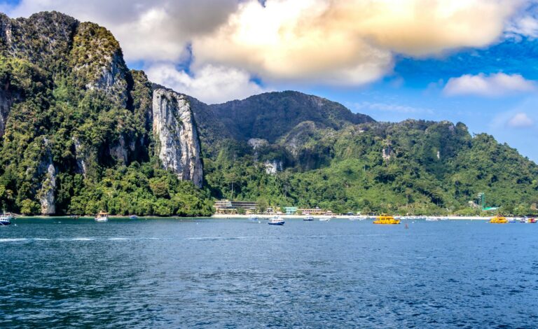 views of large limestone cliffs from the sea on a clear sunny day in Krabi / where to stay in Krabi