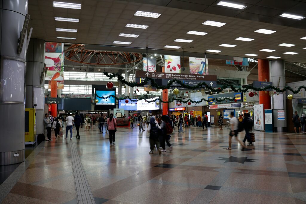 Several visitors walking throughout Kuala Lumpur International Airport 