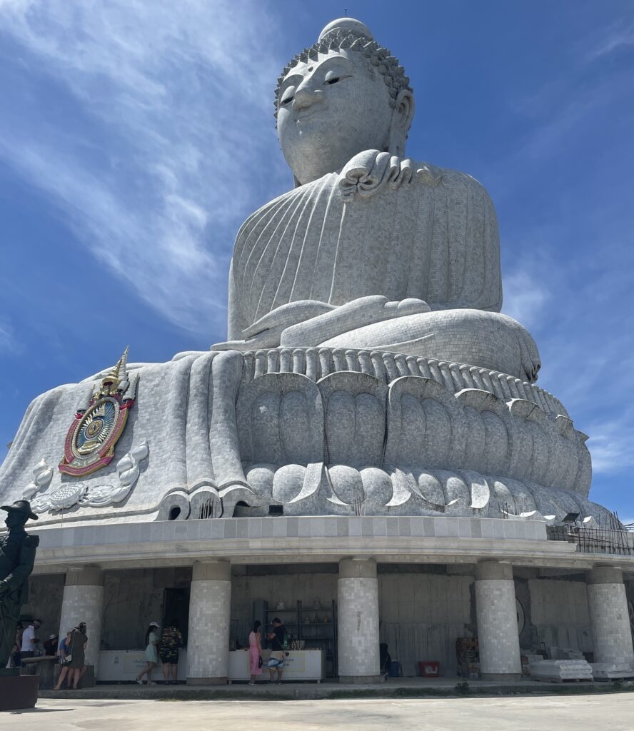 the famous Big Buddha in Phuket standing tall, a concrete Buddha statue sitting atop a hill