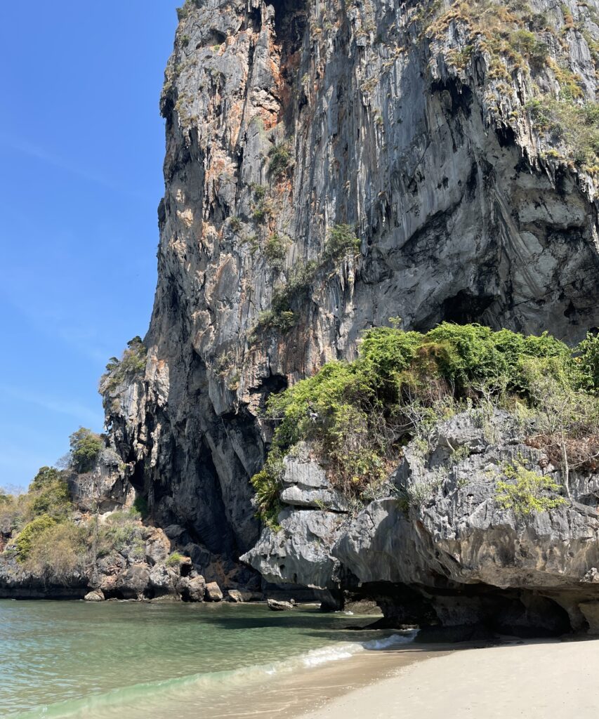 stunning towering limestones along a calm shoreline in Phra Nang Cave Beach, Railay, Krabi 