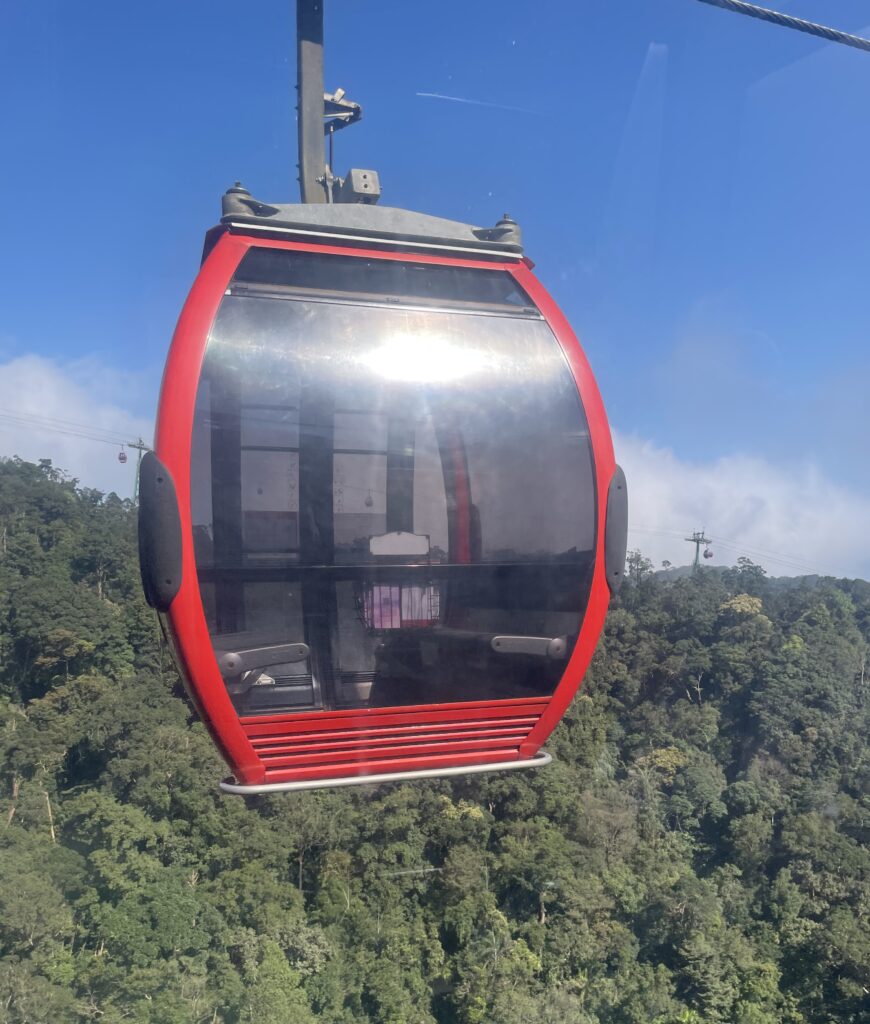 an empty red cable car moving along the Ba Na Hills in Vietnam