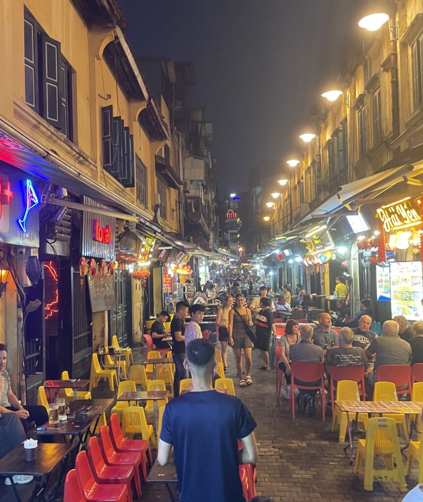 several locals and tourist dining and drinking in the Beer Street in Hanoi