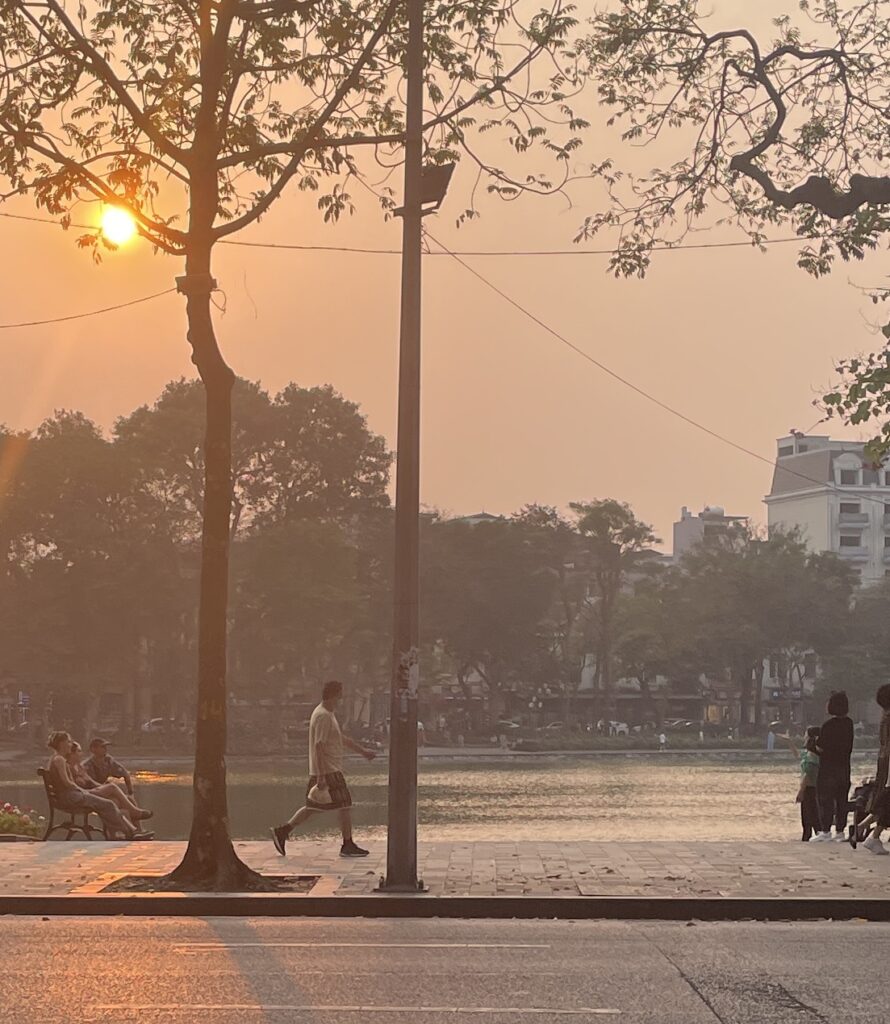 a stunning vibrant sunset over Ho Hoan Kiem Lake in Hanoi, Vietnam