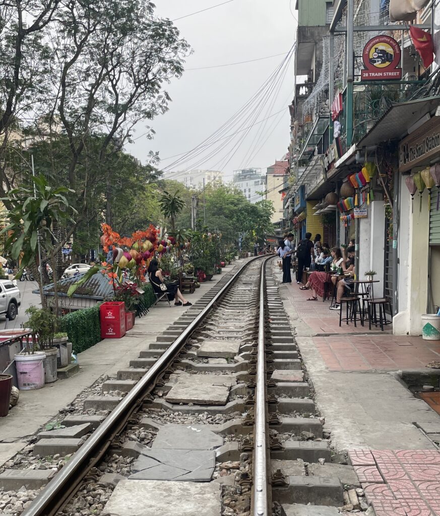 train tracks and many businesses on the side at Train Street in Hanoi
