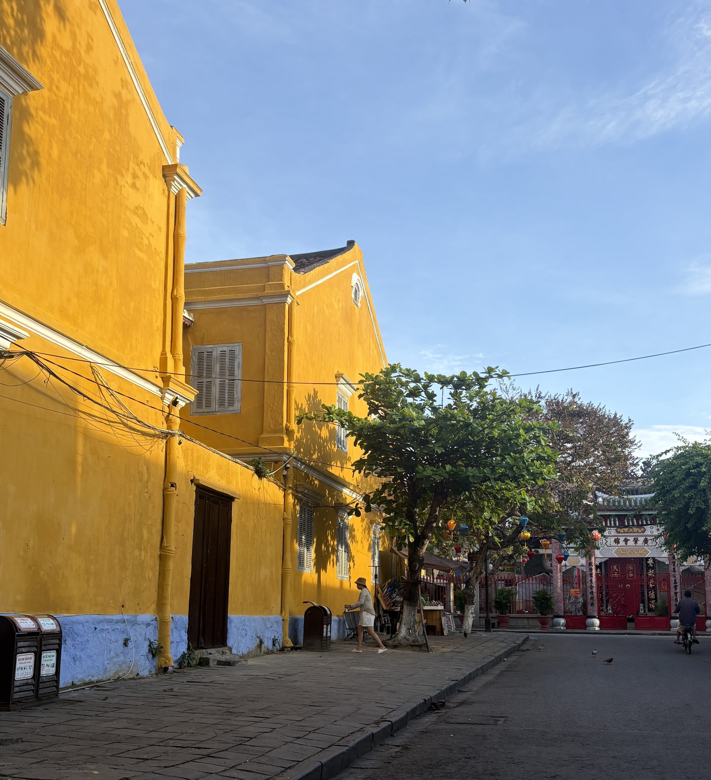 the sun hitting the bright yellow buildings in Hoi An in the morning