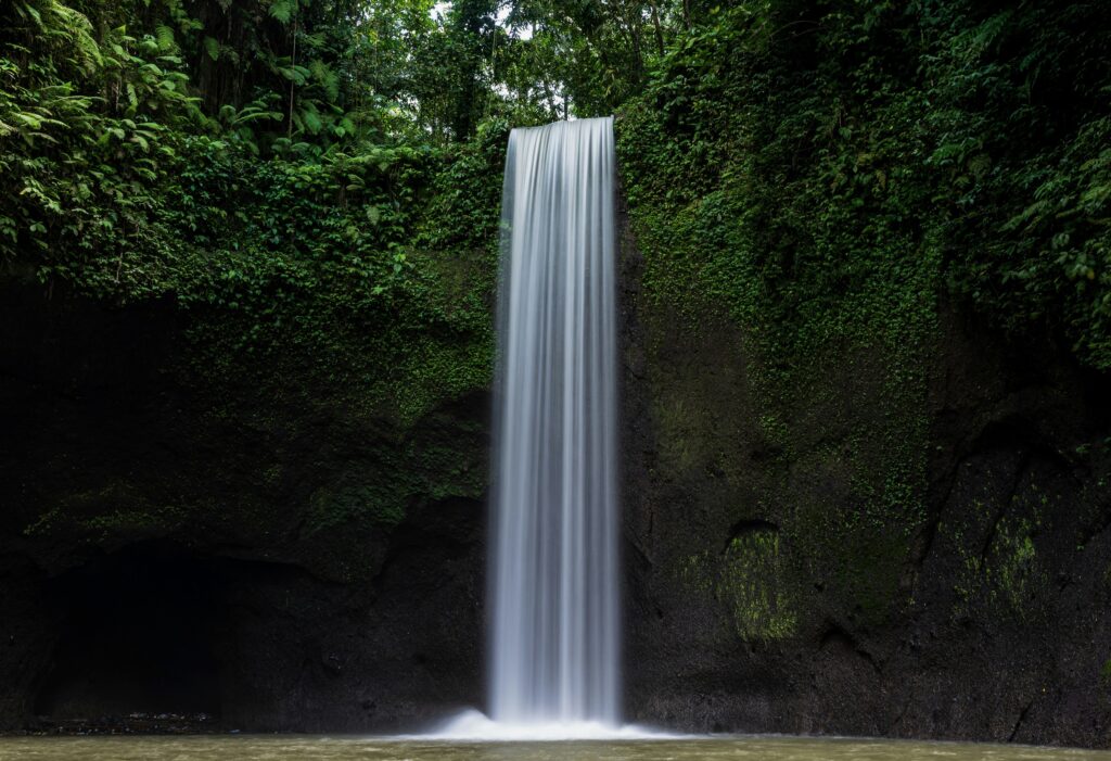 Scenic waterfall surrounded by lush jungle in Ubud, Bali