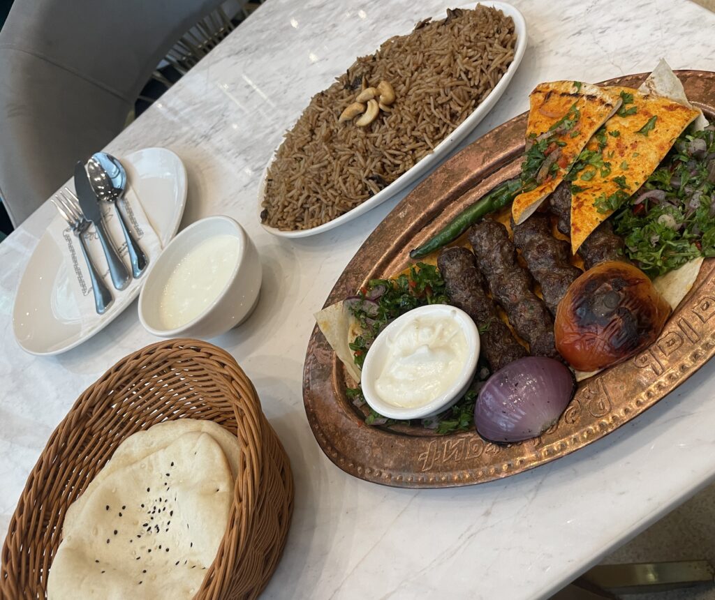 Traditional Arabic food with rice, grilled meats, and bread served at a restaurant in Kuala Lumpur