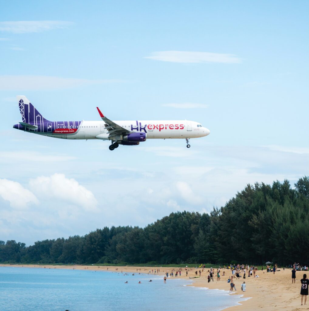 Plane flying low above Mai Khao Beach, a famous spot in Phuket for plane spotting