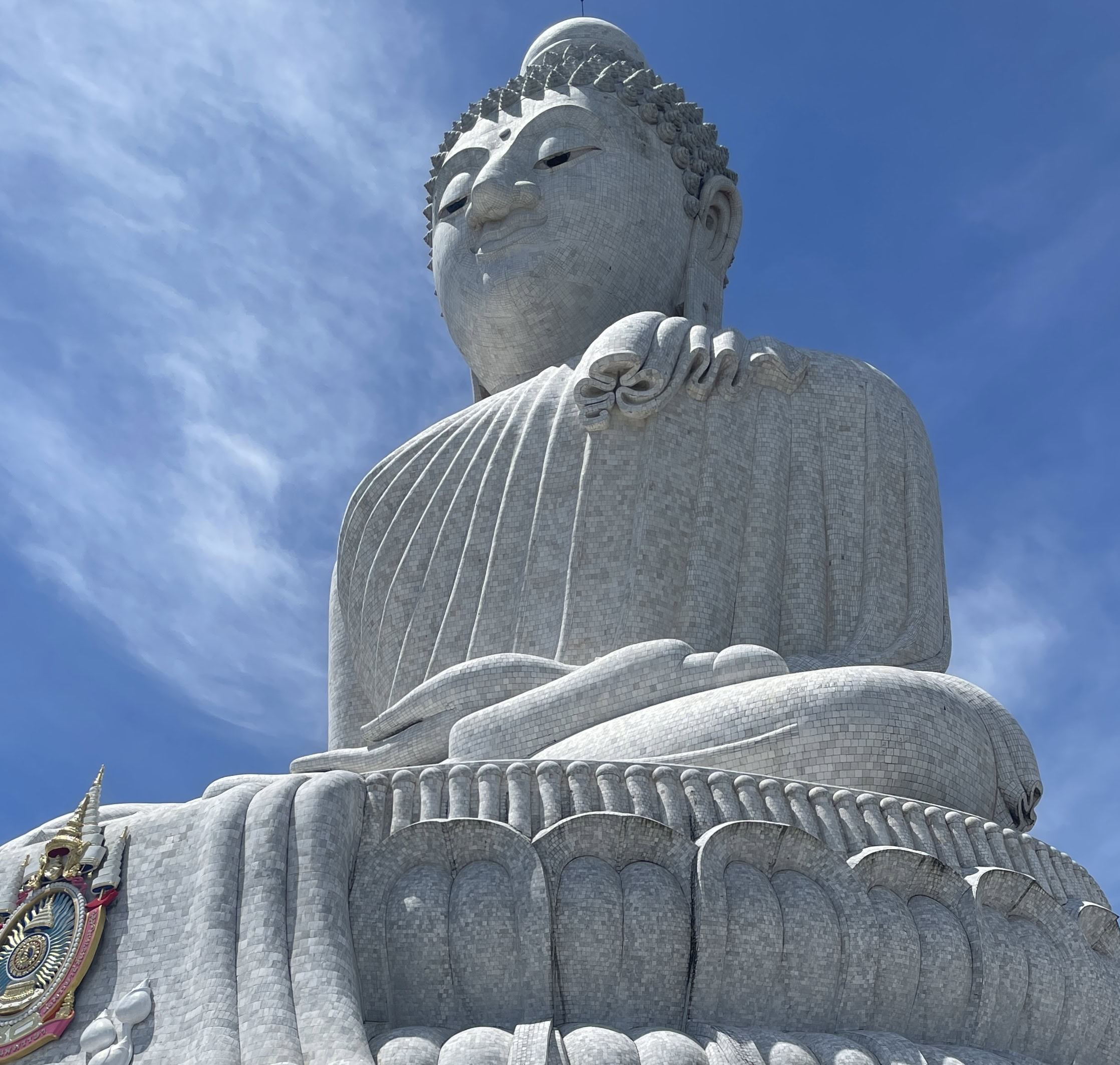 Featured image of the Big Buddha statue in Phuket on a sunny day with blue skies overhead