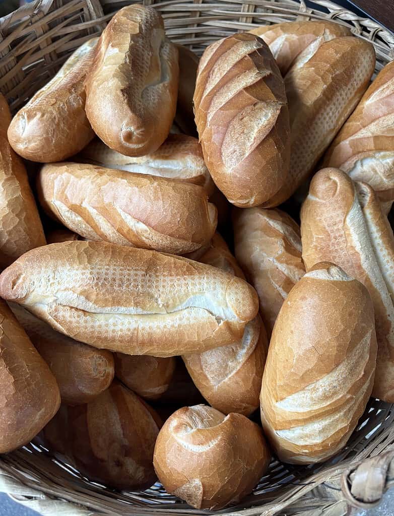 Freshly baked Vietnamese banh mi bread served alongside Bo Ne in Saigon.