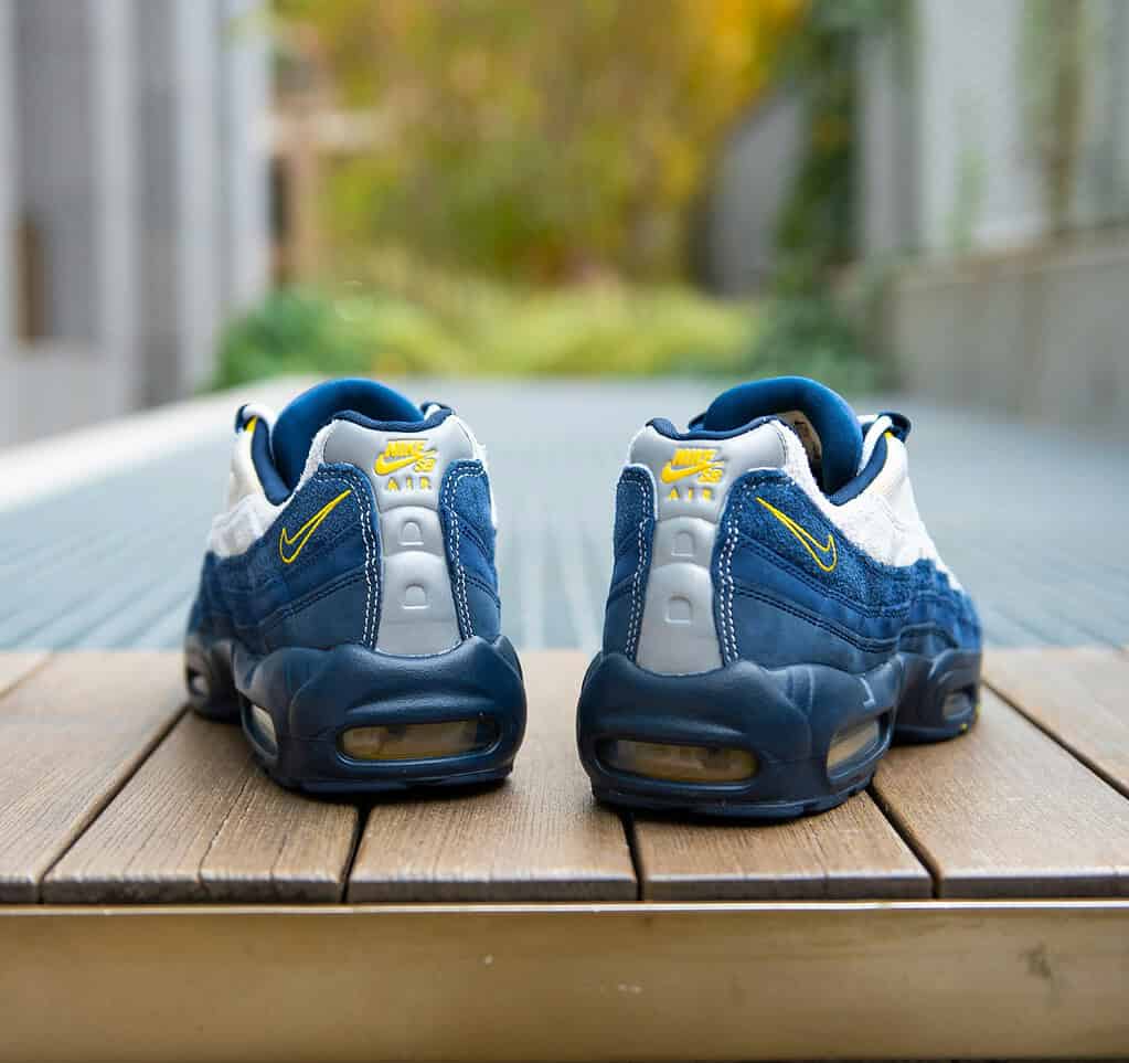 A pair of Nike shoes sitting outside on a sunny day, ideal for walking during travel.
