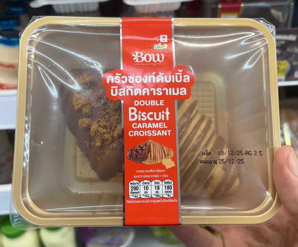 Double biscuit caramel croissant from Thailand 7-Eleven, a flaky pastry snack filled with sweet caramel and biscuit layers.
