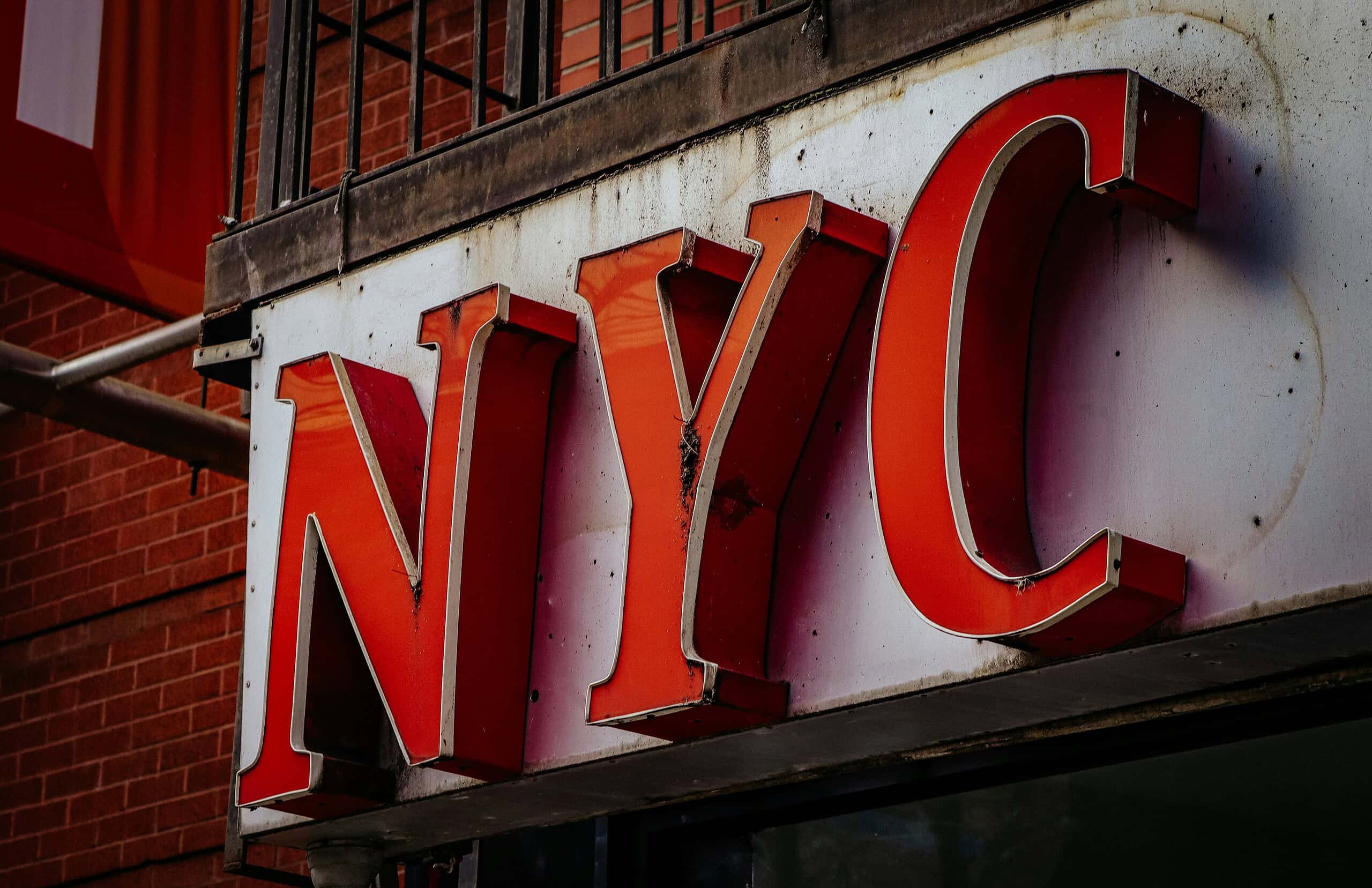 Sign displaying NYC in bold red letters