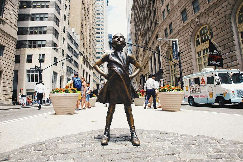 Fearless Girl statue facing the New York Stock Exchange on Wall Street, NYC
