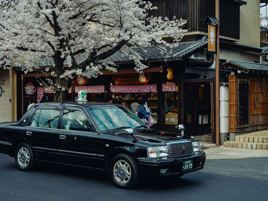 Classic black vintage taxi cab on a street in Japan