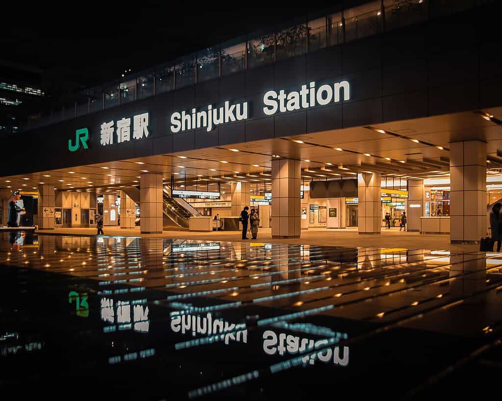 Illuminated Shinjuku Station sign lit up at night in Tokyo Japan
