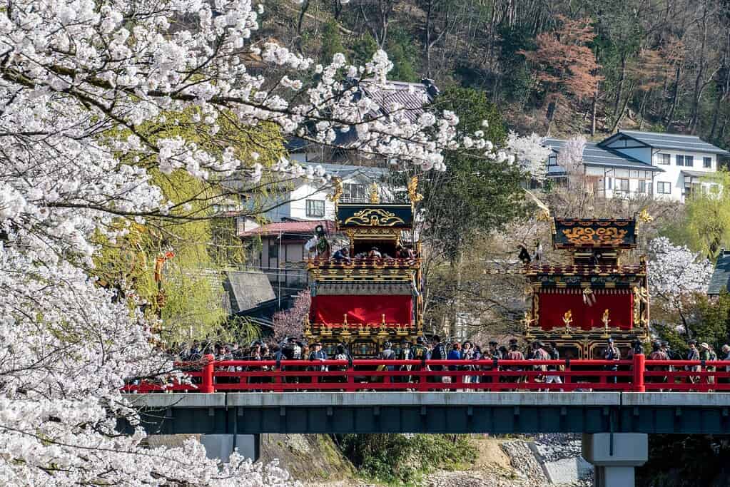 many tourist walking over a bridge in Takayama 
