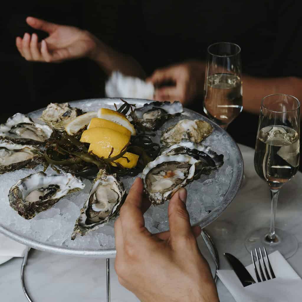oysters being served on ice with champagne 