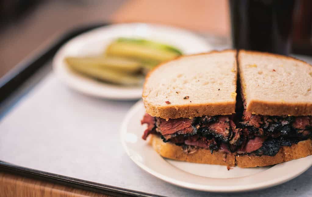 a pastrami sandwich with pickles from Katz Deli NYC 