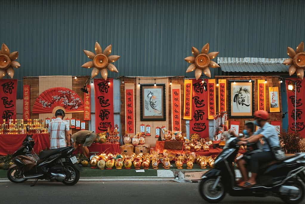 many Tet decorations and locals passing by in Saigon