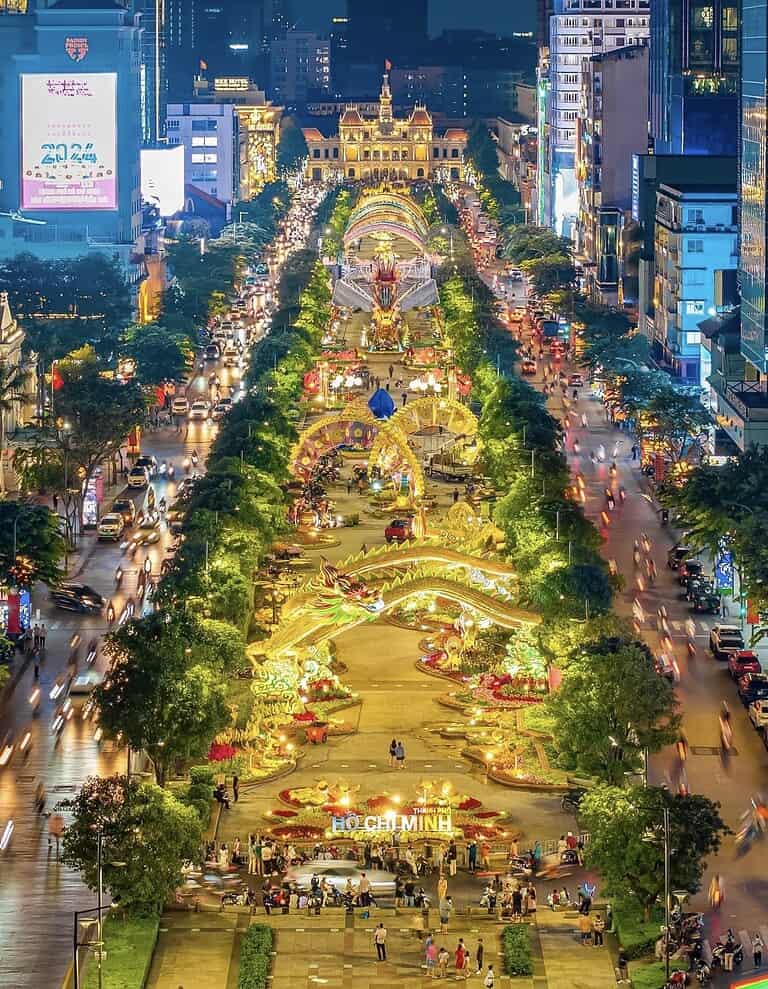 Aerial view of Nguyen Hue Boulevard in Ho Chi Minh City Vietnam lit up with elaborate Tet decorations and dragon sculptures at night