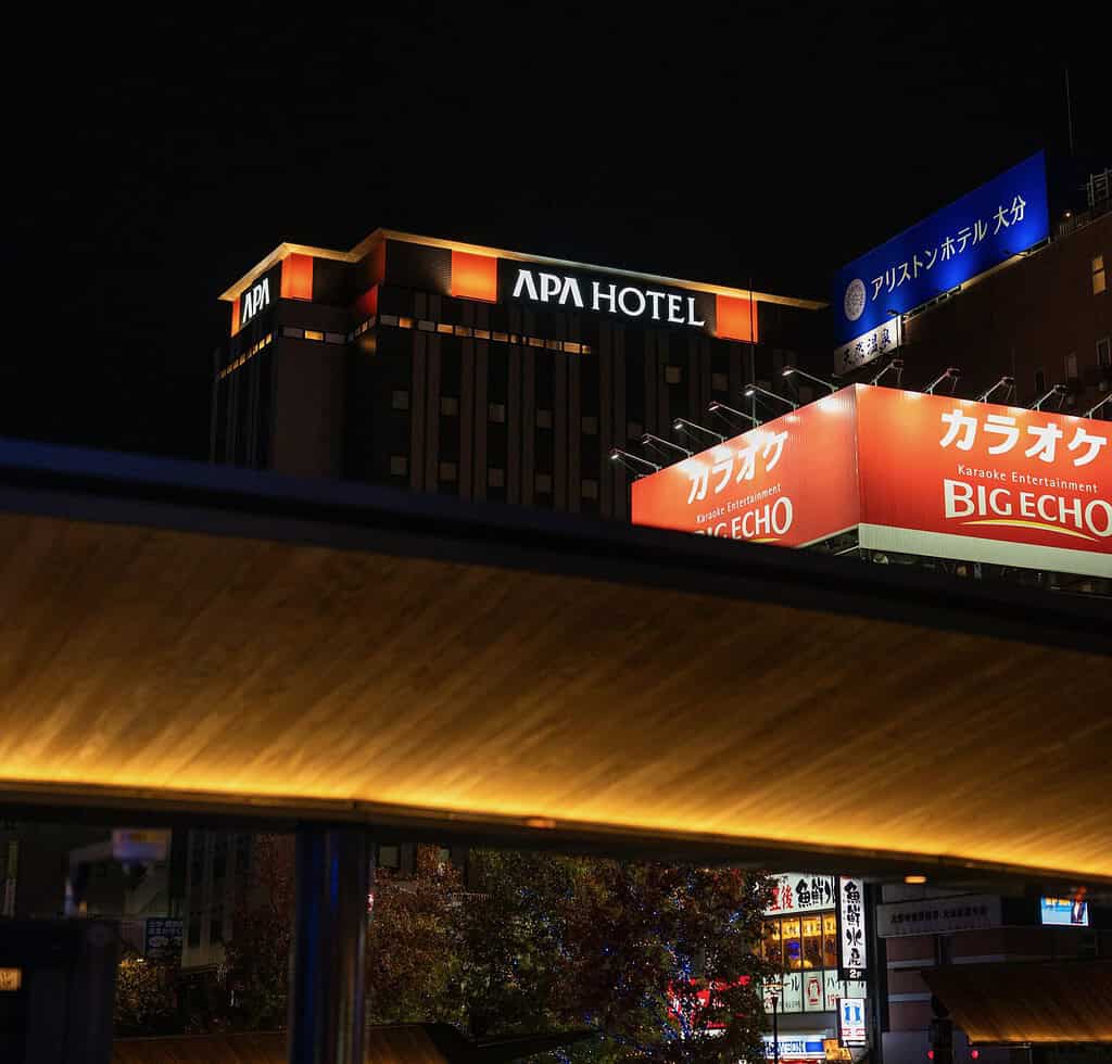 APA hotel signage lit up at night in Tokyo
