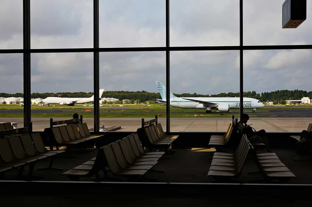 airplanes outside passing by, large windows at Narita Airport