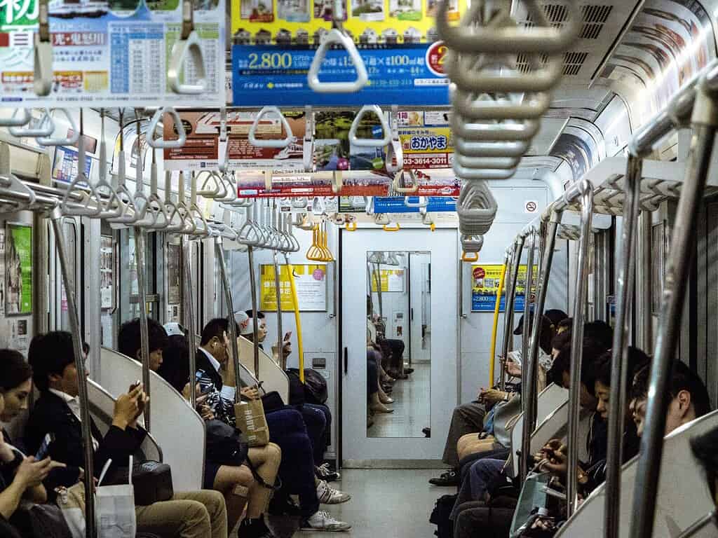 several passangers on a local subway line in Tokyo