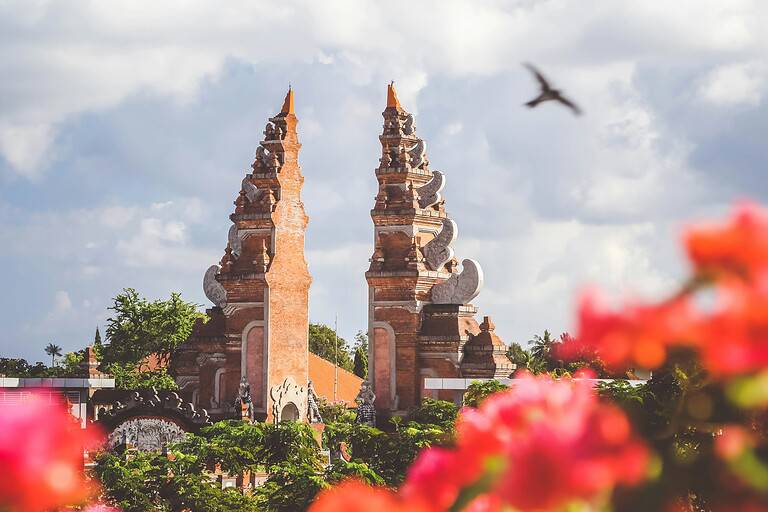 famous temple in Bali with bird flying by