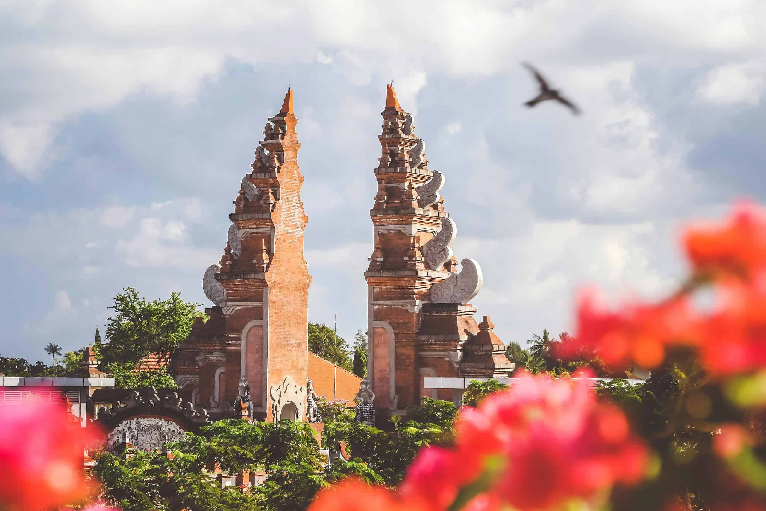 famous temple in Bali with bird flying by