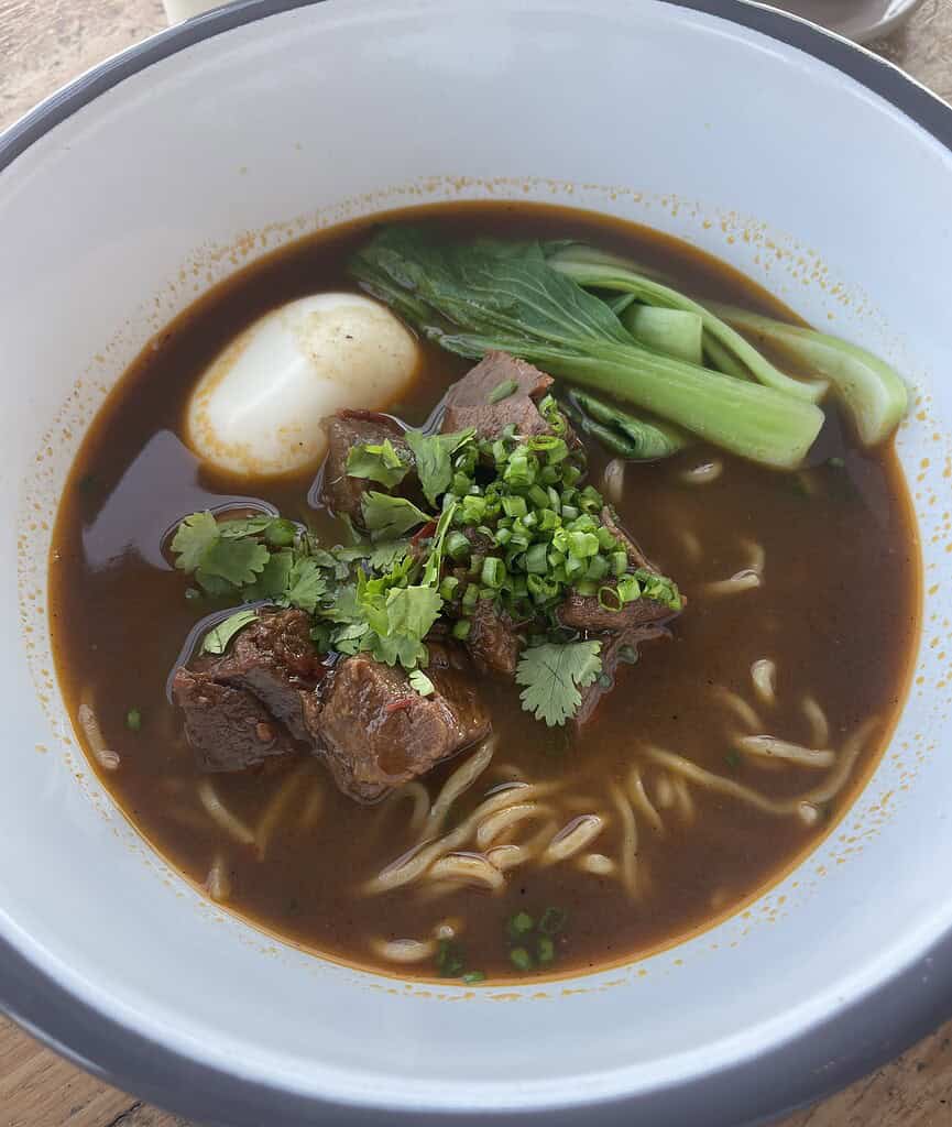 a bowl of beef noodles served in Bali