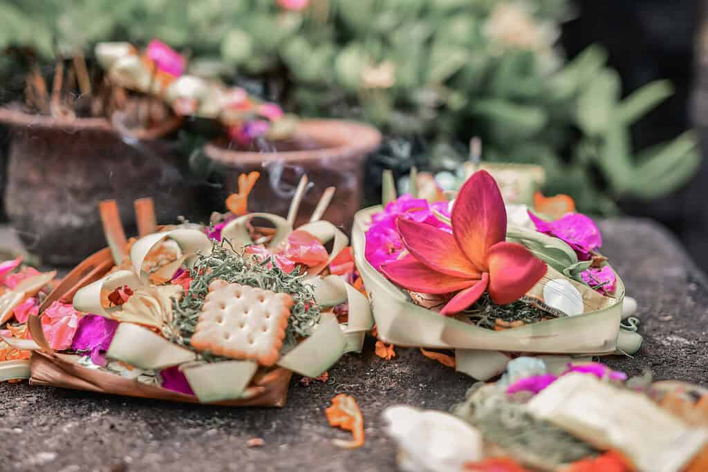 canang sari offerings on the ground in Bali